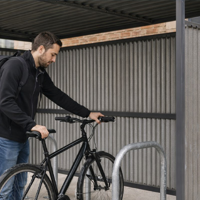 Action shot of person putting their bike inside shelter