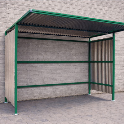 Green open-back shelter against a wall